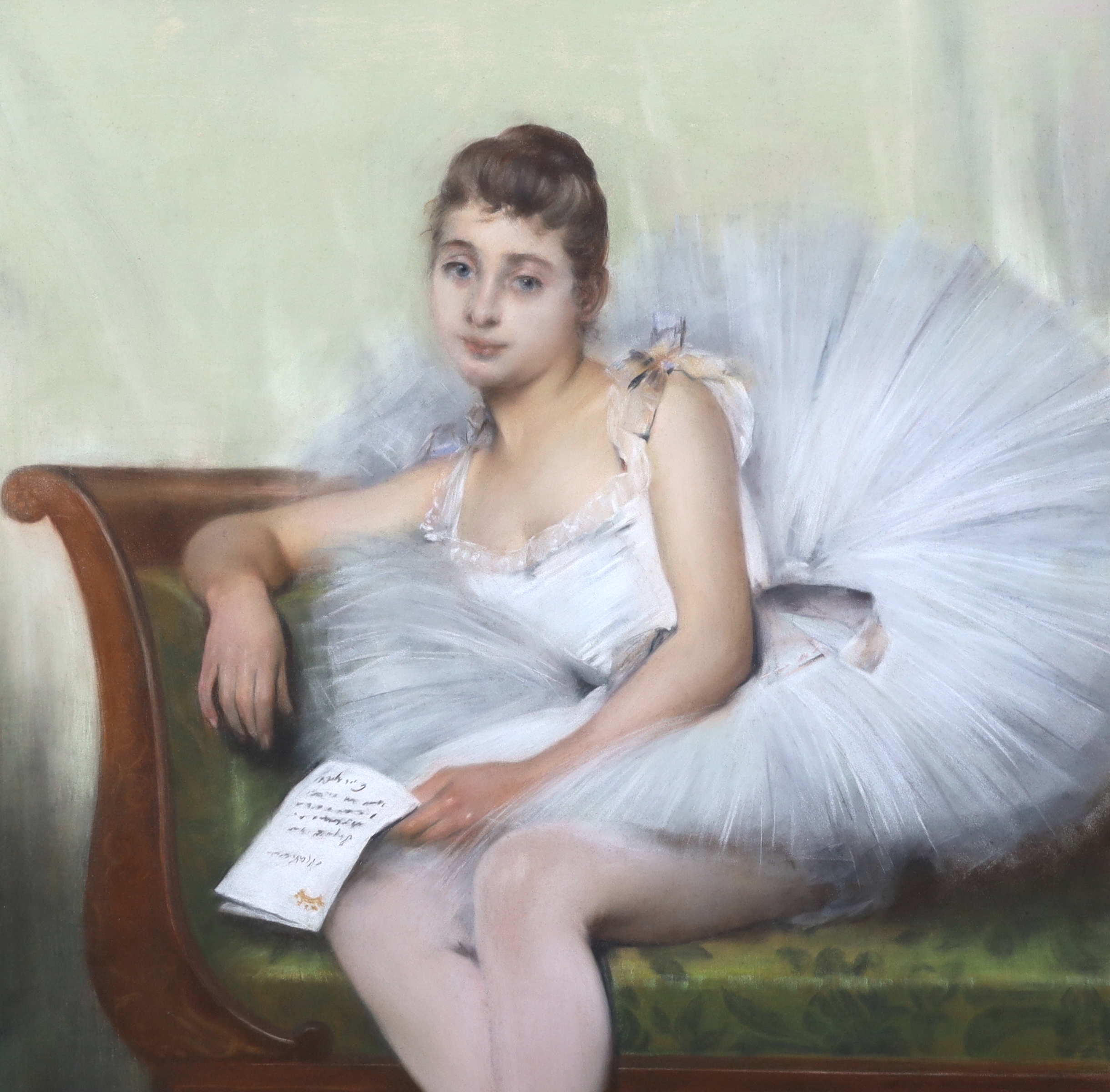 Pierre Carrier-Belleuse (French, 1851-1932), Portrait of a young ballerina seated upon a couch, holding a letter, pastel, 99 x 71cm